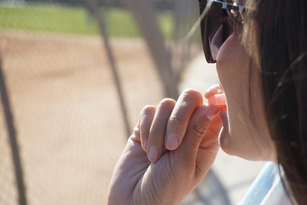 woman eating cbd gummies