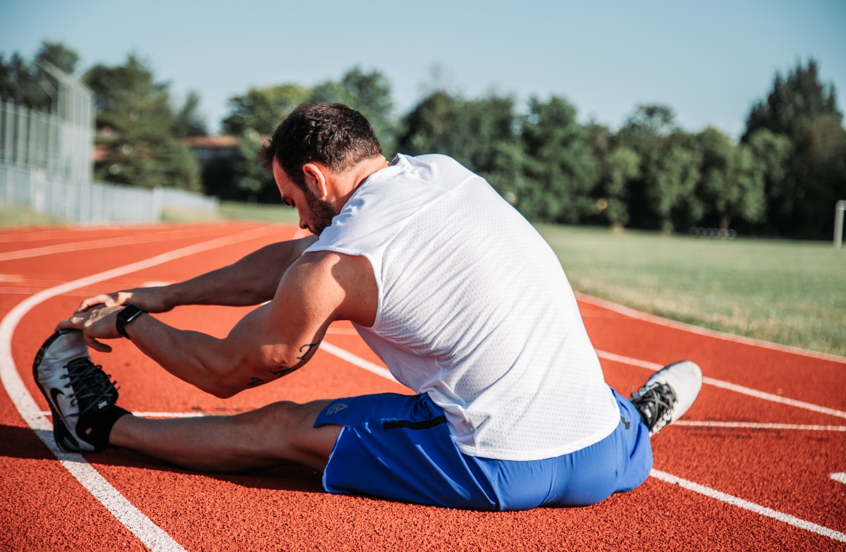 Man stretching before workout to help prevent injury