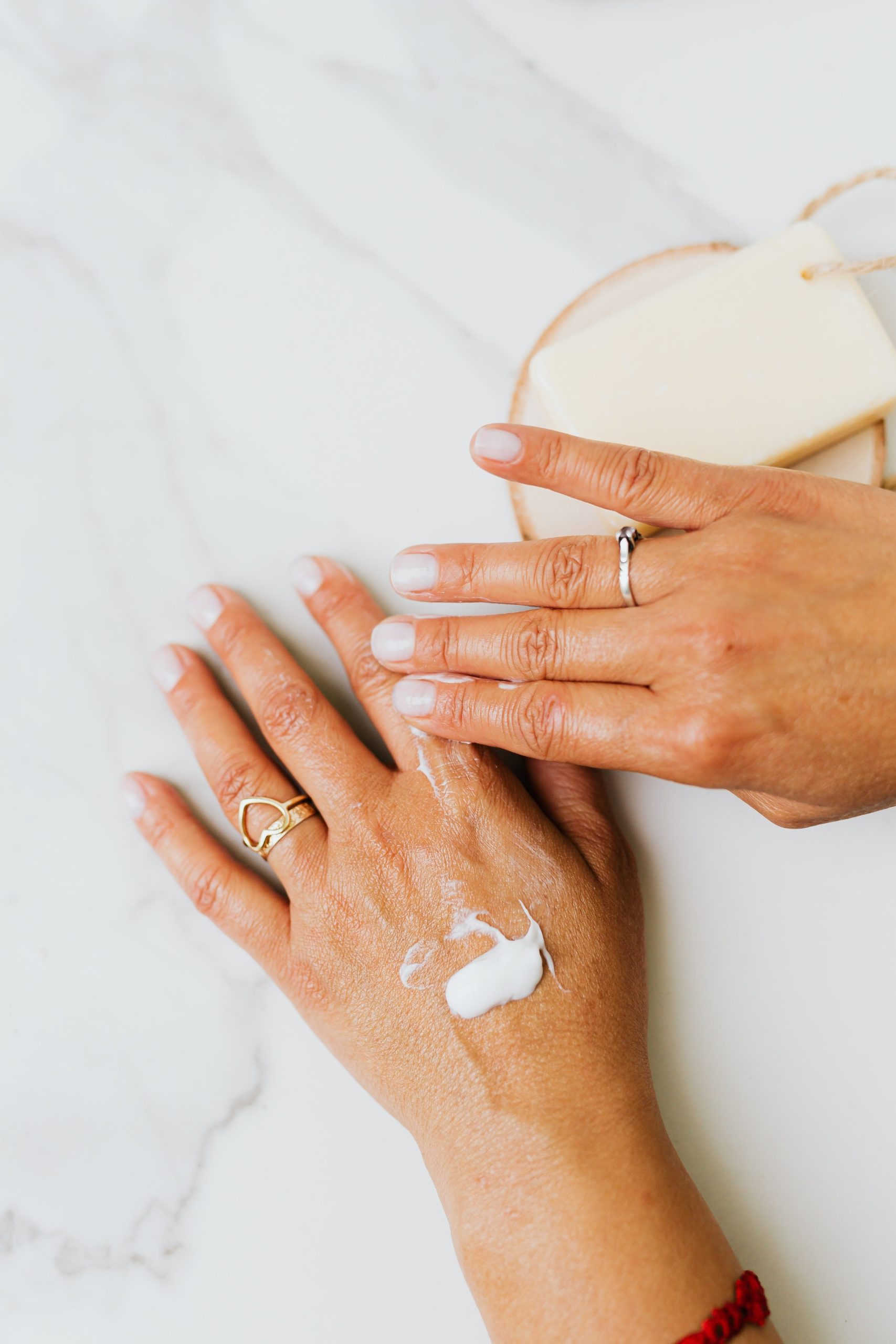 Woman's hands with white cream