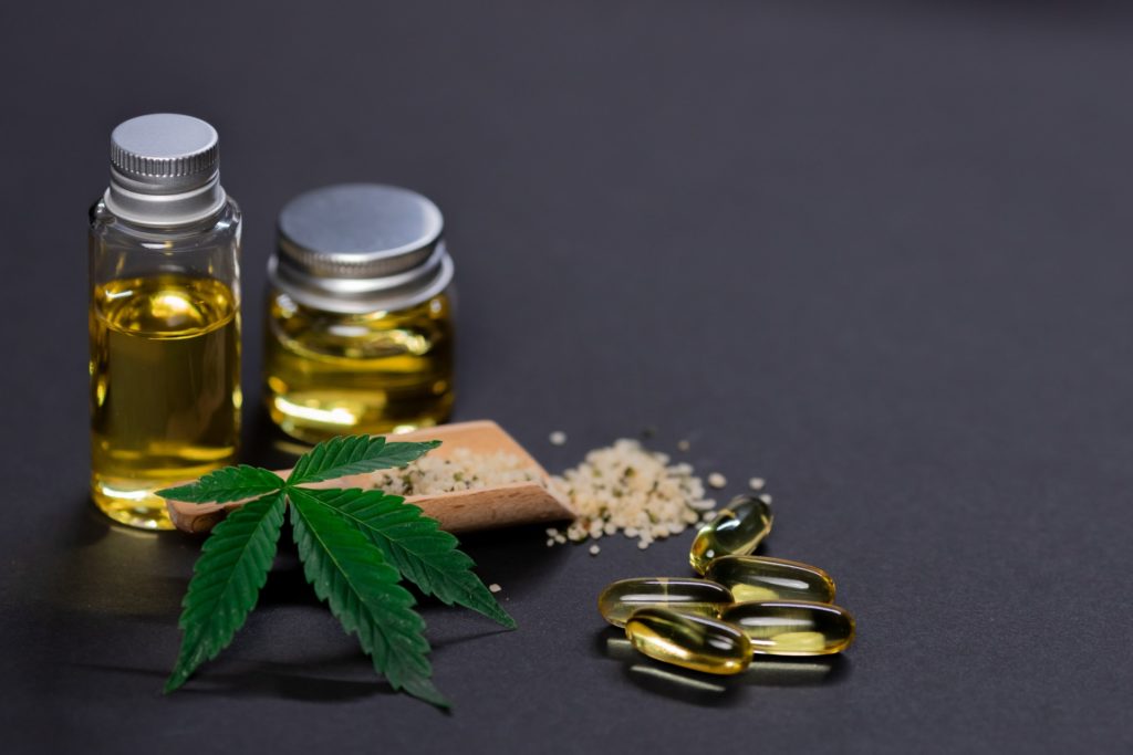 cbd oil and cbd capsules on the table