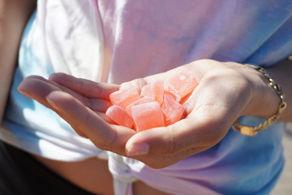 person holding cbd gummies in their hands